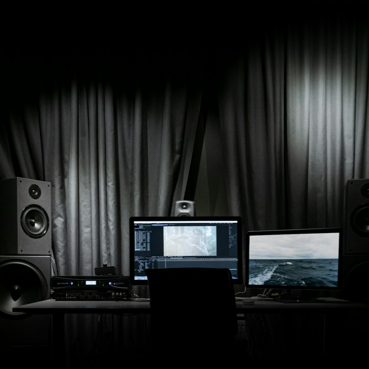 A close-up shot of Number Six working in his state-of-the-art recording studio, surrounded by synthesizers, mixing consoles, and computer screens. The atmosphere is creative and focused, with a sense of limitless possibilities.